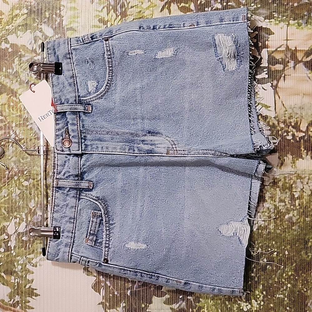 Distressed denim shorts featuring raw hem